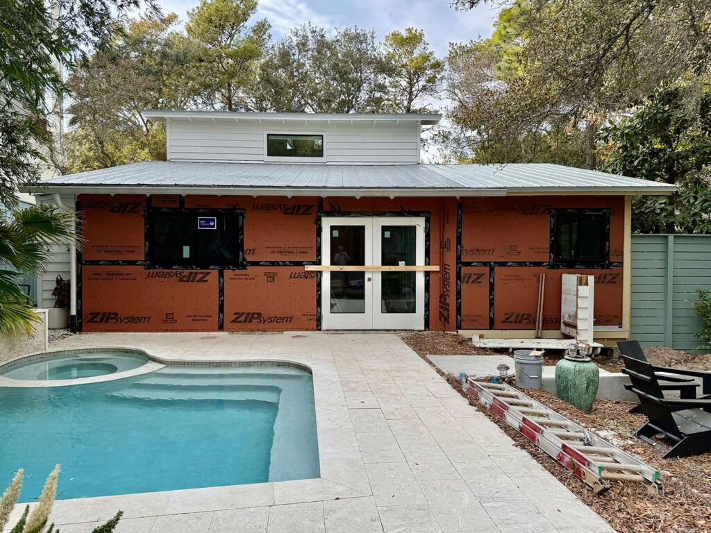View Of Home Exterior During Renovation With Pool