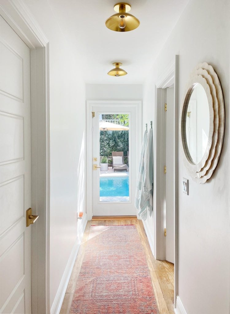 downstairs-hallway-to-pool-morning-sunlight-750x1024-1 Hallway With Traditional Rug Leading To Pool