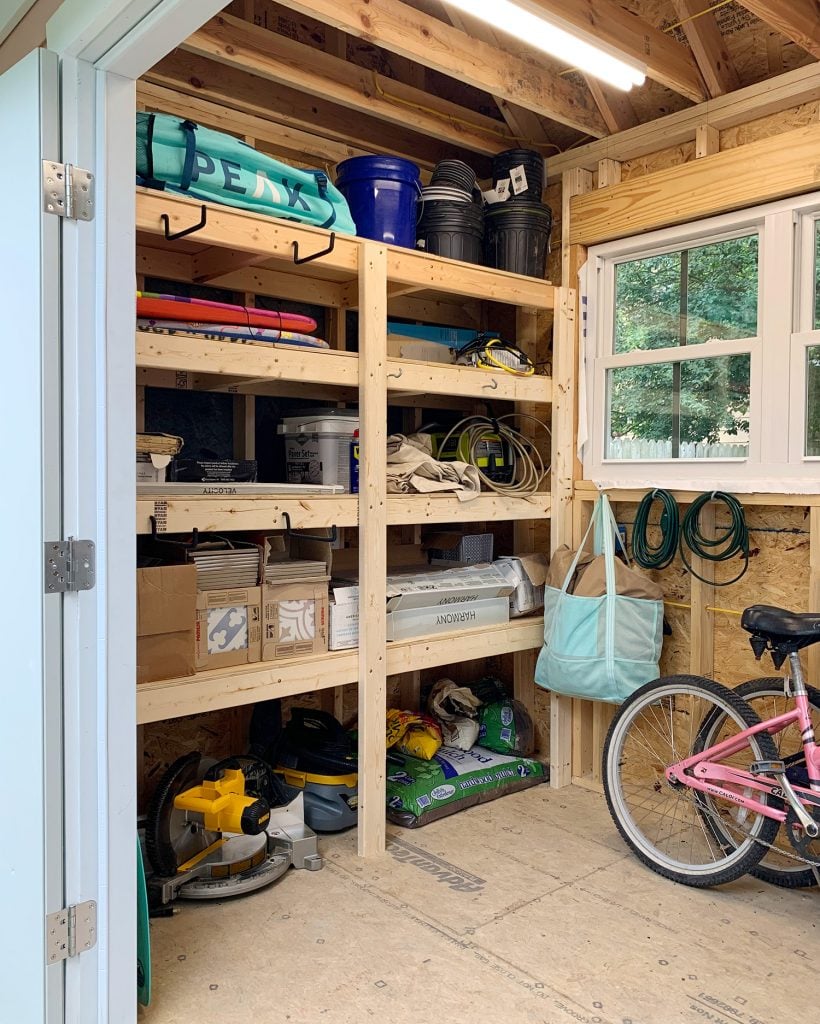 beach-shed-organization-shelves-with-stuff-820x1024-1 Heavy duty wood shelves in beach house storage shed