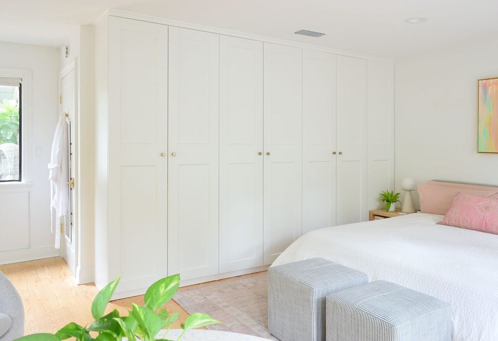 bedroom-pax-wardrobe-table-foreground-1024x701-1 Row of Ikea Pax Wardrobe Closets In Bedrom With Gold Knobs