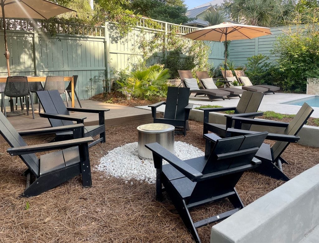 bigger-pool-backyard-firepit-area-1024x780-1 Solo Stove firepit area with black Adirondack Chairs