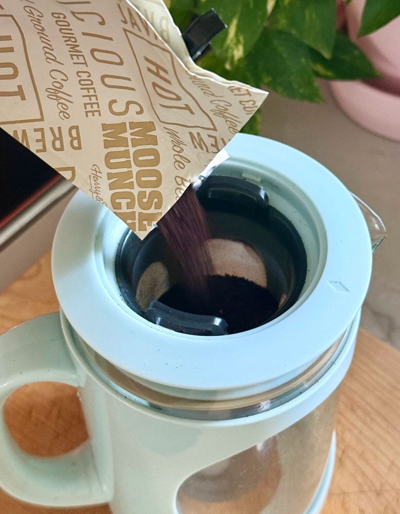 cold-brew-maker-pouring-coffee-grounds-in-797x1024-1 Adding Ground Coffee To Filter Of Cold Brew Maker