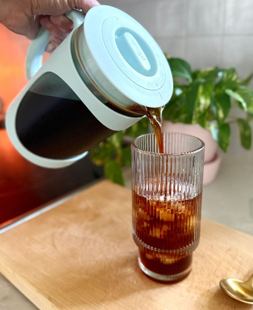 cold-brew-maker-pouring-into-cup-835x1024-1 Pouring Homemade Cold Brew Into Glass With Ice