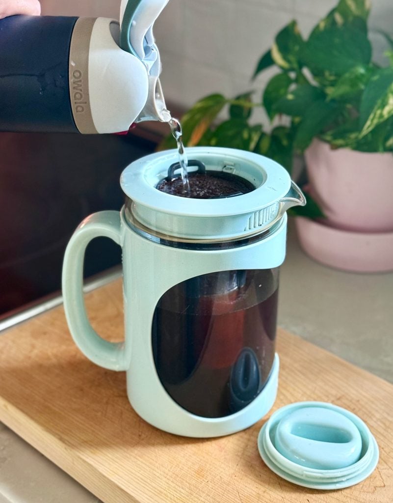 cold-brew-maker-pouring-water-in-801x1024-1 Adding Water Over Coffee Grounds In Home Cold Brew Maker