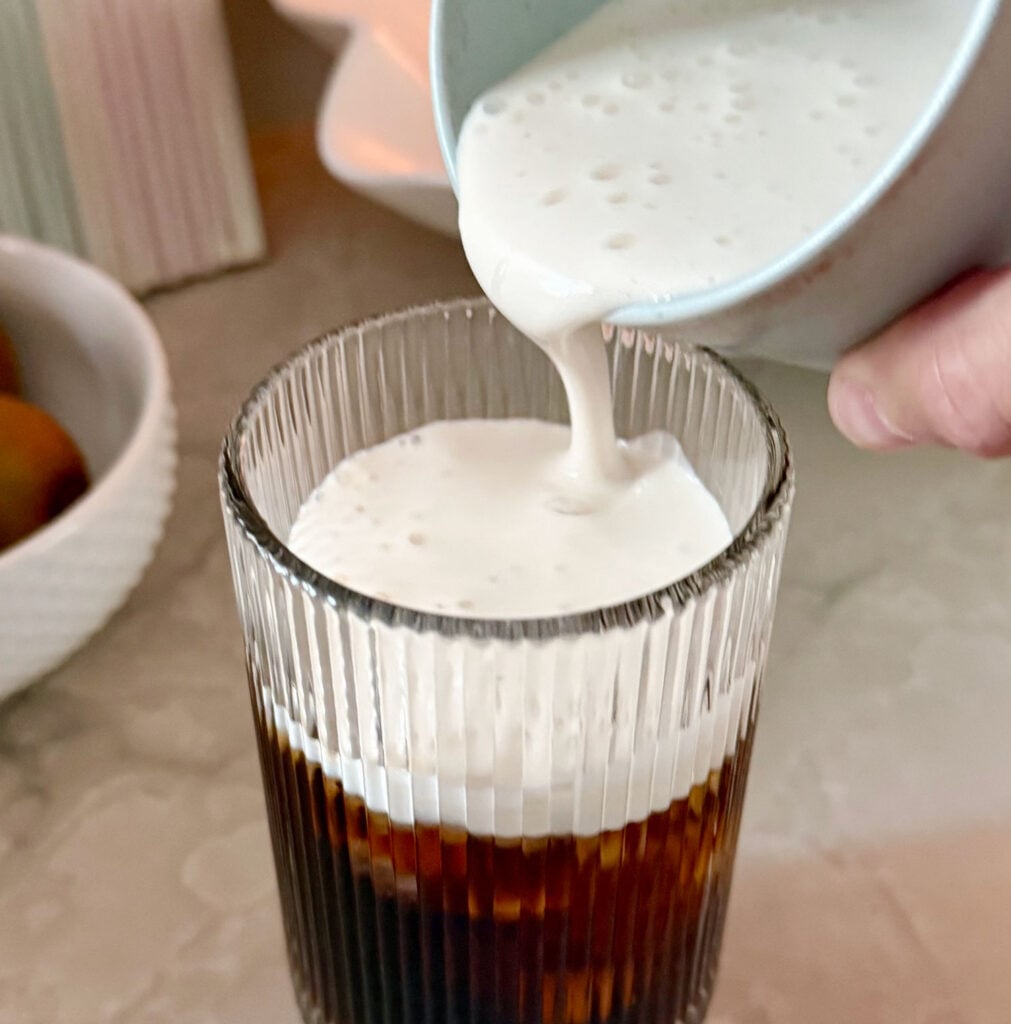 cold-foam-on-cold-brew-at-home-1011x1024-1 Pouring homemade cold foam creamer over cold brew coffee