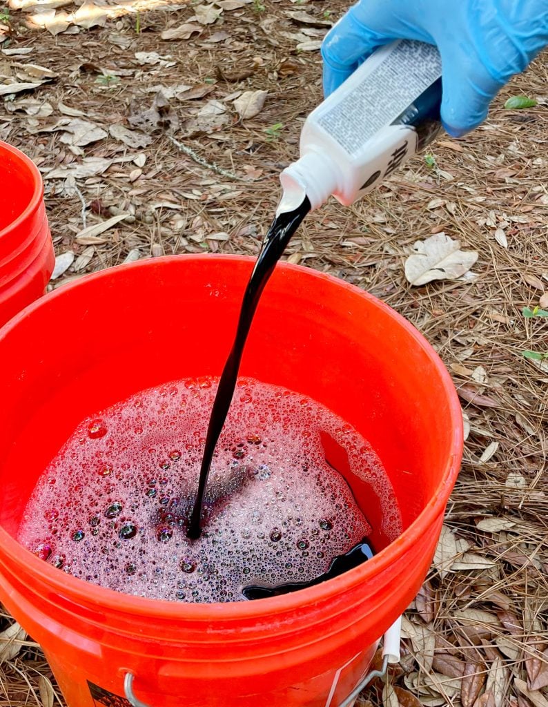 dye-clothes-pouring-rit-black-dye-in-bucket-794x1024-1 Pouring Bottle Of Black Rit Fabric Dye Into Hot Water Bucket