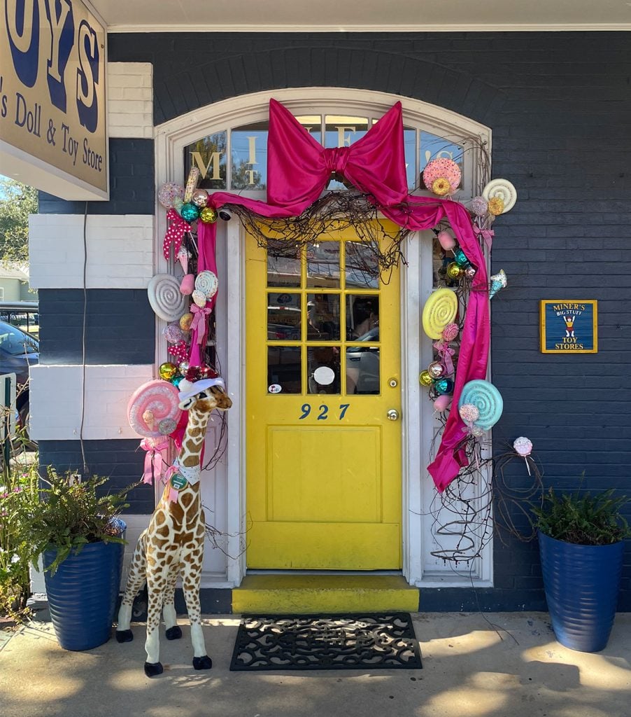 ocean-springs-miners-toy-store-902x1024-1 Decorated Yellow Front Door For Miners Doll and Toy Store In Ocean Springs Mississippi