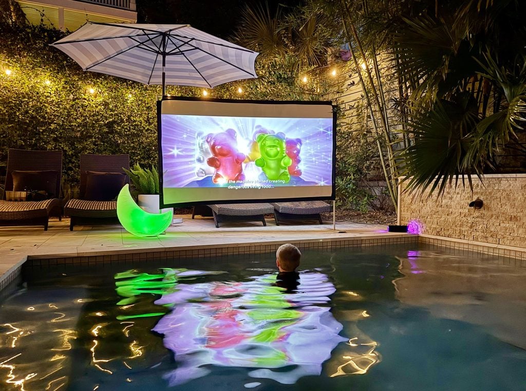 outdoor-movie-night-boy-watching-in-pool-1024x760-1 Outdoor Movie Night In Pool With Projector And Screen