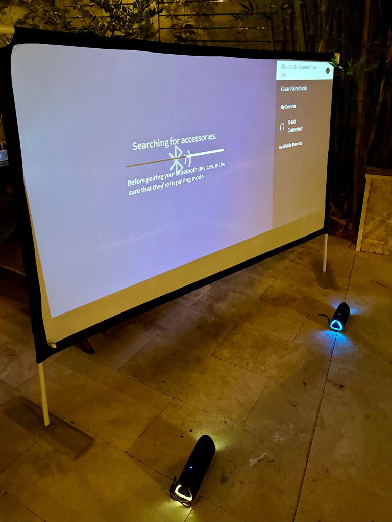 outdoor-movie-night-pairing-speakers-768x1024-1 Bluetooth Pairing Wireless Speakers to Outdoor Movie Projector