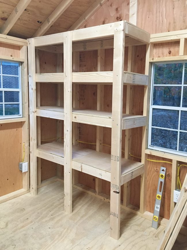 shed-storage-wood-frame-flat-surfaces-on-650x867-1 finished DIY garage shelves with three vertial supports