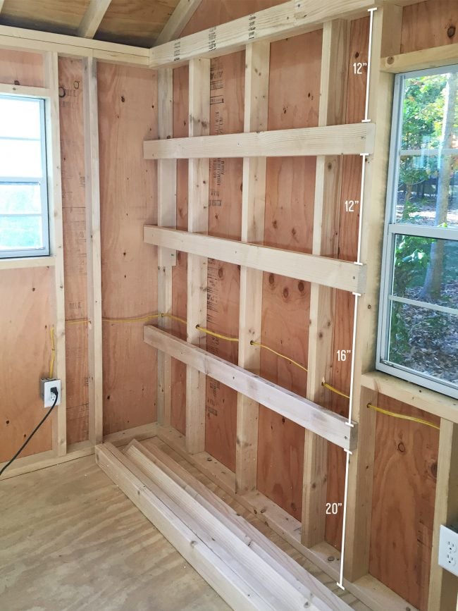 shed-storage-wood-shelves-first-boards-hung-650x867-1 wood shelf supports attached to shed wall for DIY garage shelves