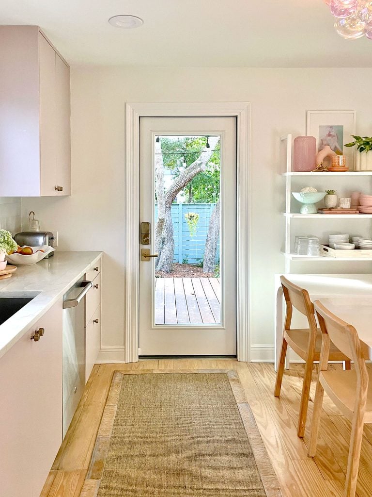 Small Kitchen With Mauve Cabinets And Doorway To Porch