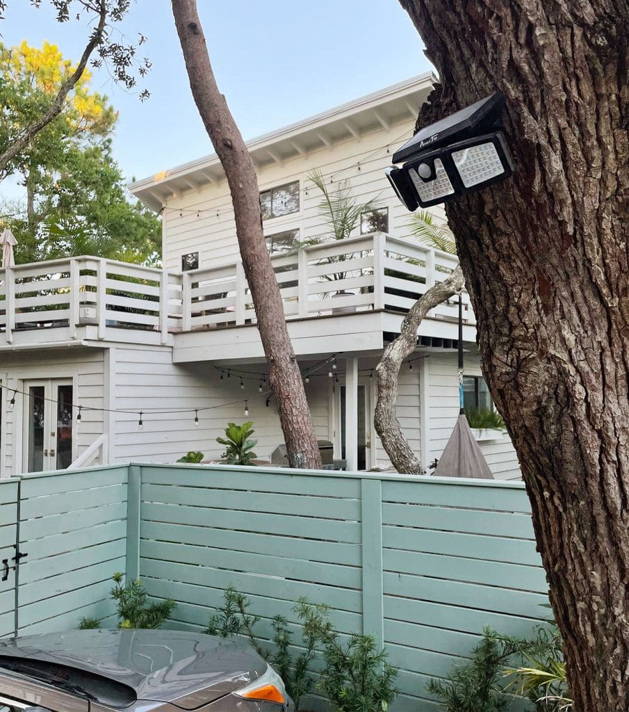backyard-solar-light-security-flood-light-on-tree-905x1024-1 Solar powered flood light mounted above parking area