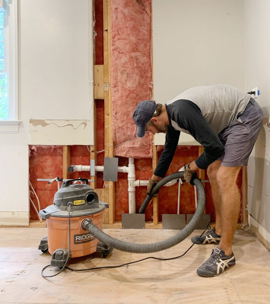 bathroom-john-vacuuming-up-dust-909x1024-1 John Using Shop Vac To Remove Dust During Bathroom Renovation