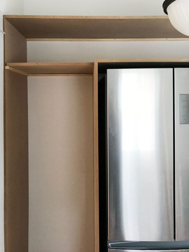 beach-beach-pantry-day-one-end-straight-650x867-1 front view of pantry shelves with top shelves already added
