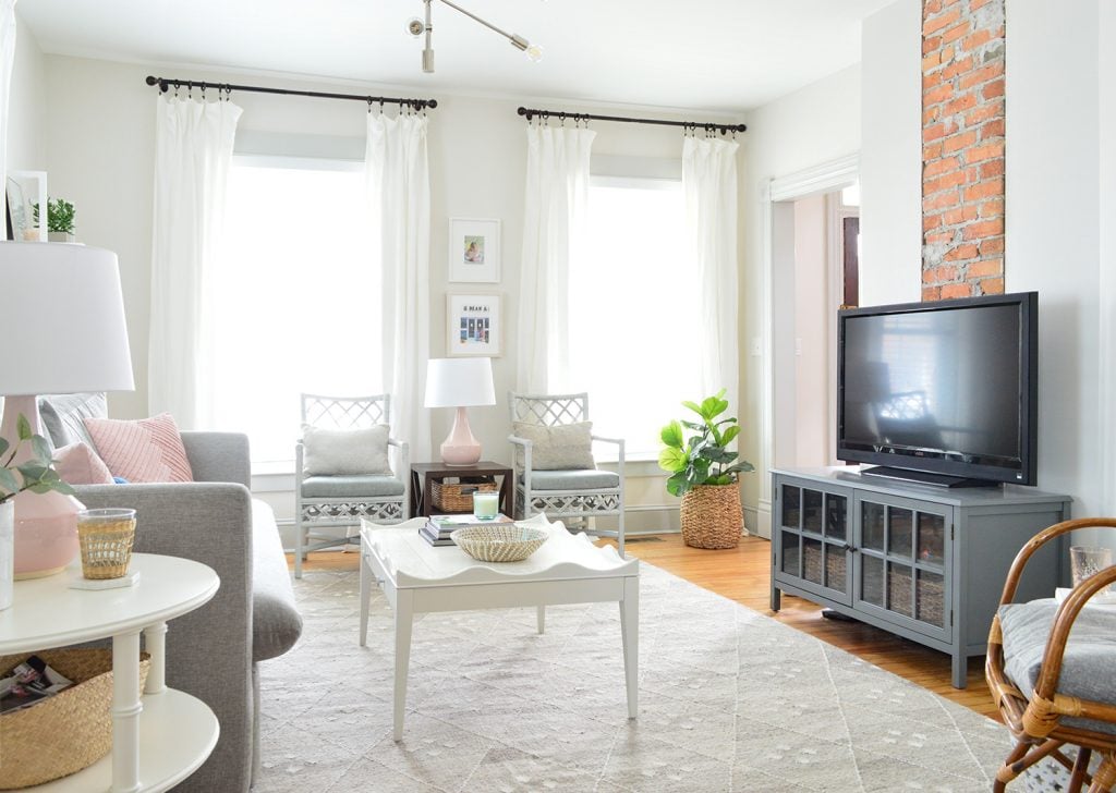 beach-house-living-new-couch-horizontal-to-chimney-1024x728-1 Beach house living room with exposed brick fireplace and two windows with floor to ceiling white curtains