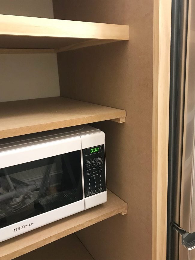 beach-house-pantry-facing-strips-on-650x867-1 1x2 wood pieces attached to front of shelves to make them look thicker