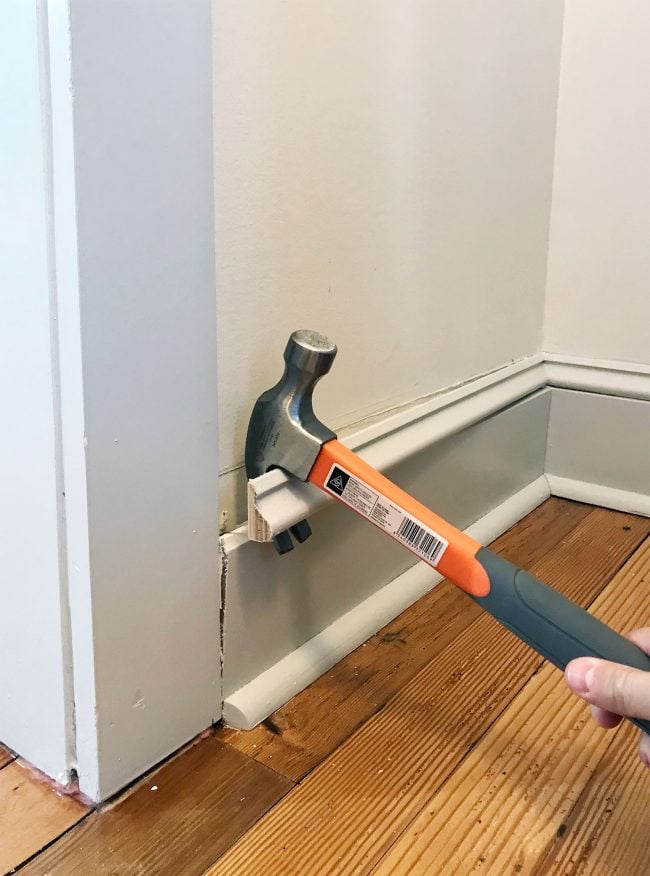 beach-house-pantry-prying-off-trim-650x876-1 hammer prying off baseboard molding in pantry