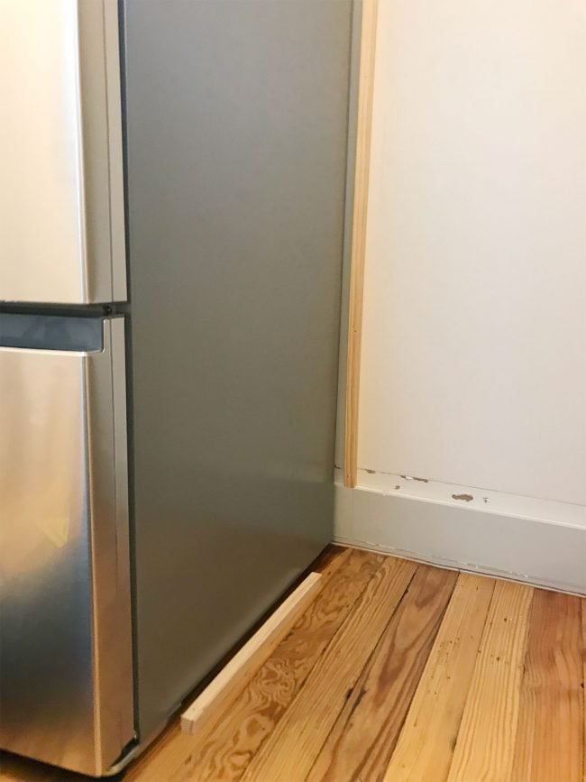 beach-house-pantry-vertical-braces-650x867-1 thing pieces of wood installed near fridge on wall and floor