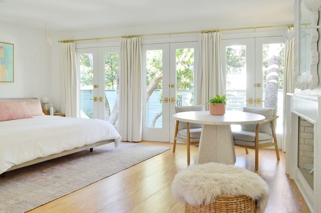 beachy-bedroom-wall-of-doors-1024x681-1 Bright Beachy Bedroom With Wall Of French Doors And Curtains