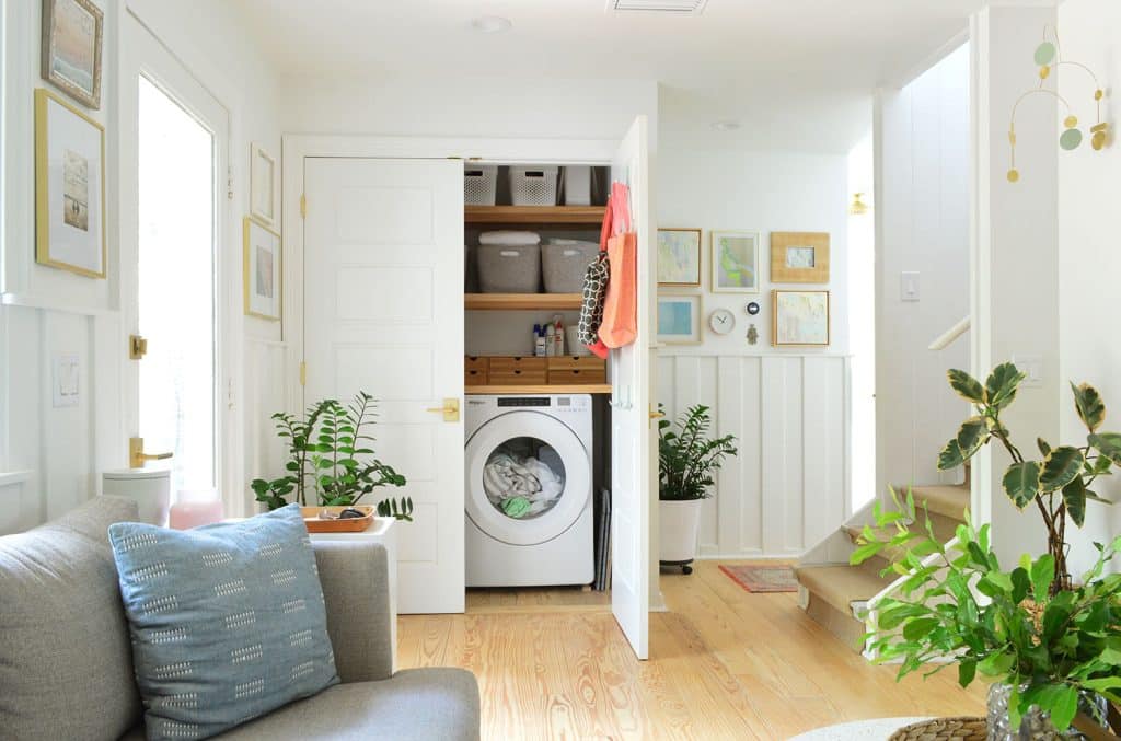 beachy-kitchen-laundry-one-door-1024x677-1 One Door Open In Open Laundry Closet Behind Seating Area In Kitchen