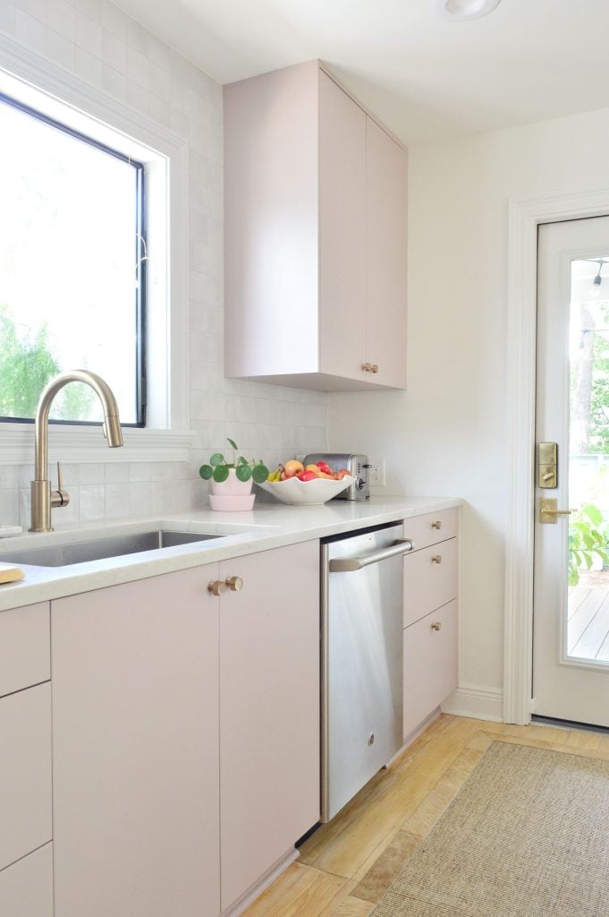 beachy-kitchen-porch-dishwasher-door-681x1024-1 Angled View Of Painted Mauve Pink Kitchen Cabinets With Gray Backsplash