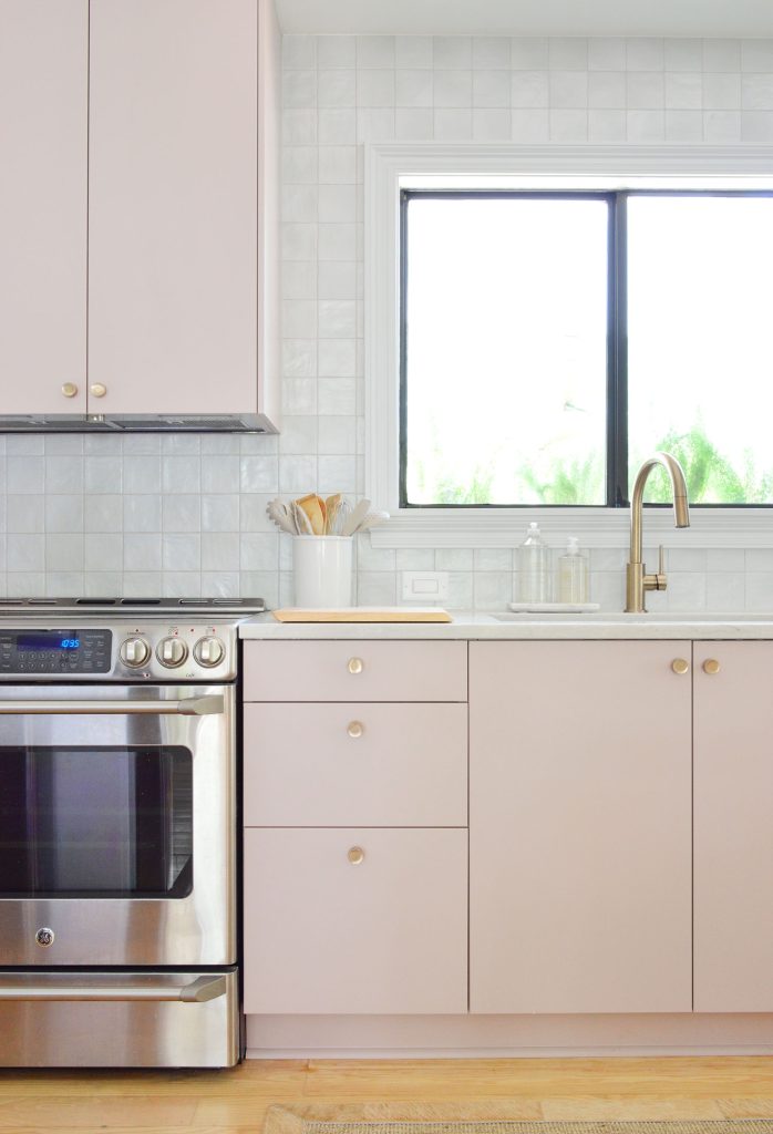 beachy-kitchen-sink-stove-vertical-698x1024-1 Vertical View Of Mauve Pink Painted Ikea Kitchen Cabinets With Gray Tile Backsplash