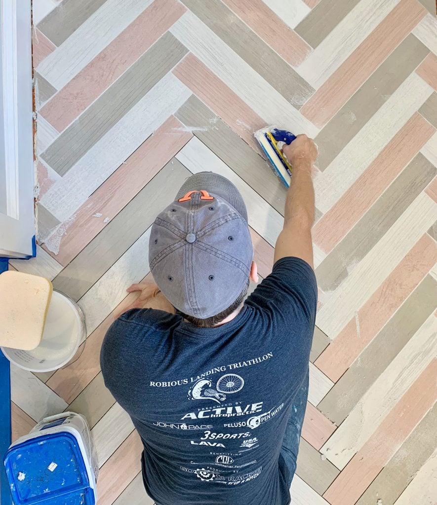 best-grout-multicolor-herringbone-mudroom-john-grouting-885x1024-1 John grouting a colorful herringbone mudroom floor with mapei grout