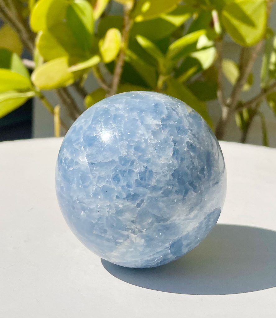 blue-calcite-crystal-orb-with-plants-888x1024-1 Blue Calcite Sphere With Plant