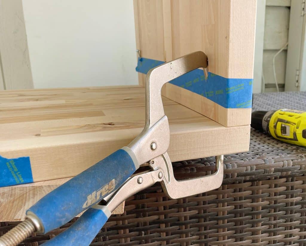 butcher-block-nightstand-kreg-jig-clamp-1024x823-1 Kreg Pocket Hole Clamp Holding Butcher Block Nightstands Together During Construction