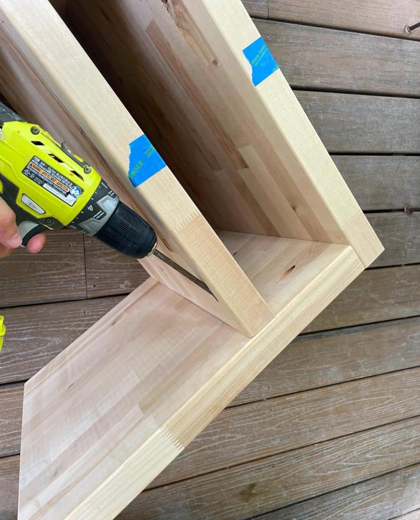 butcher-block-nightstand-screwing-shelf-827x1024-1 Attaching Shelf Inside Butcher Block Nightstand DIY Build