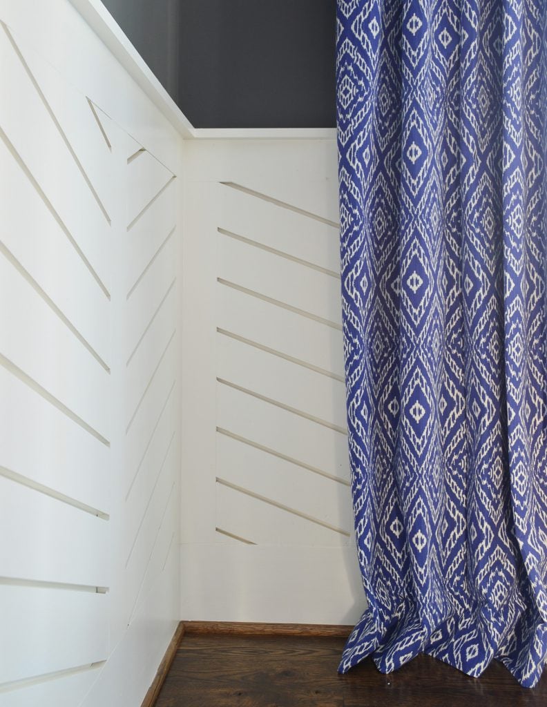 curtain-examples-showhouse-dining-room-wainscot-detail-792x1024-1 Chevron wainscotting with blue diamond curtain hanging to graze floor