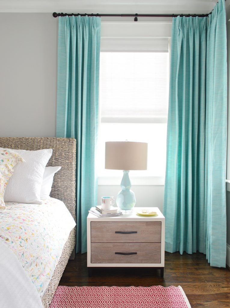 curtain-examples-showhouse-master-bedroom-detail-765x1024-1 Blue aqua curtains hanging in bedroom behind nightstand