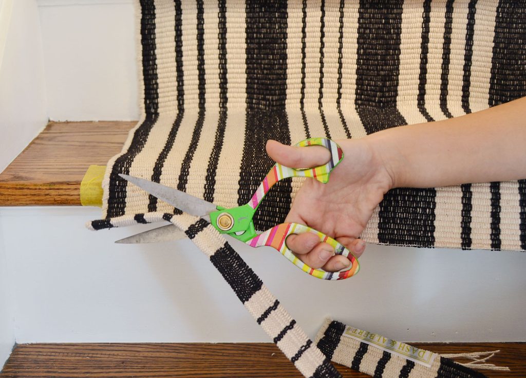 cutting-first-stair-runner-with-scissors-1024x735-1 Using scissors to trim off excess runner