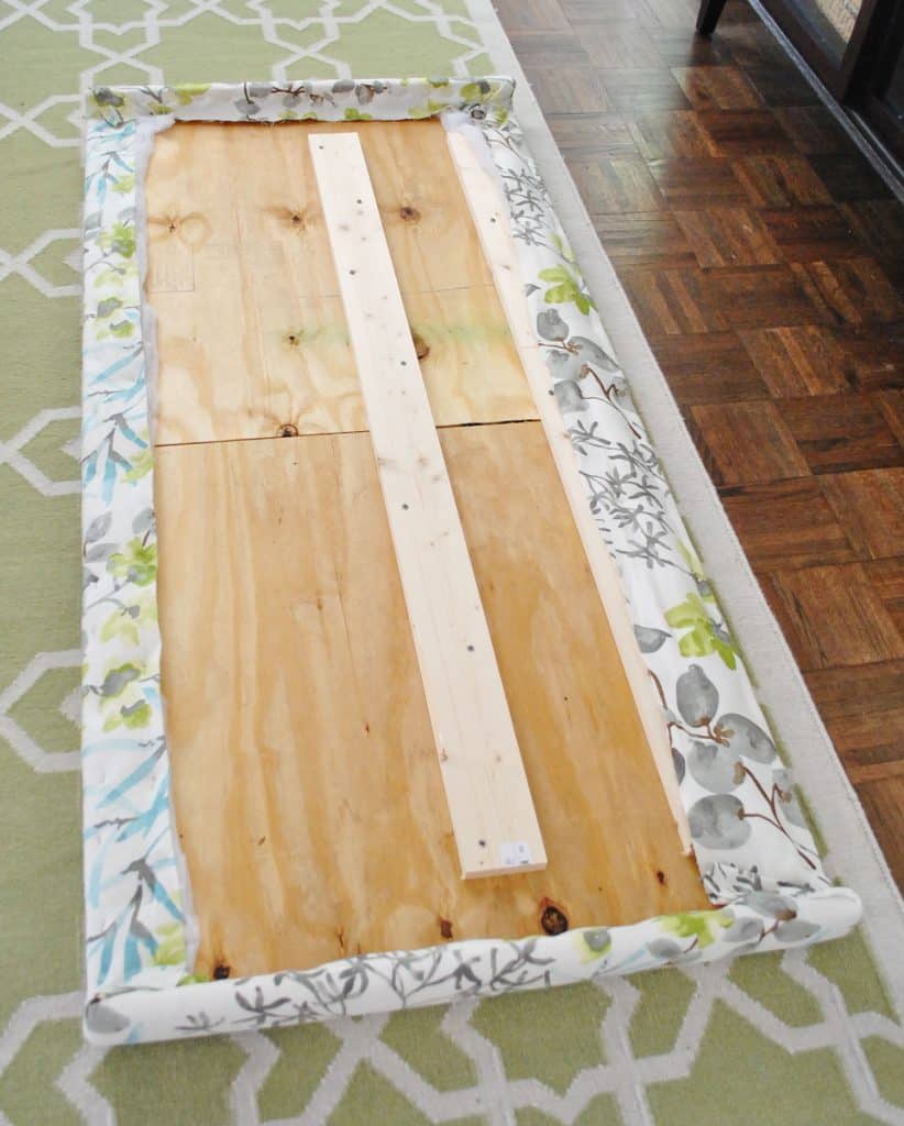 diy-upholstered-headboard-fabric-attached-822x1024-1 Fabric fully stapled along the backside of wooden headboard frame