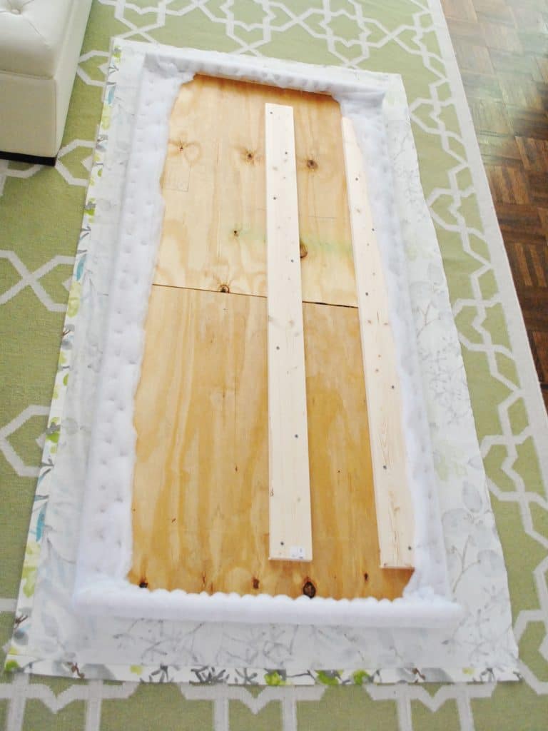 diy-upholstered-headboard-fabric-laid-out-768x1024-1 Fabric and headboard frame laid out to begin upholstery