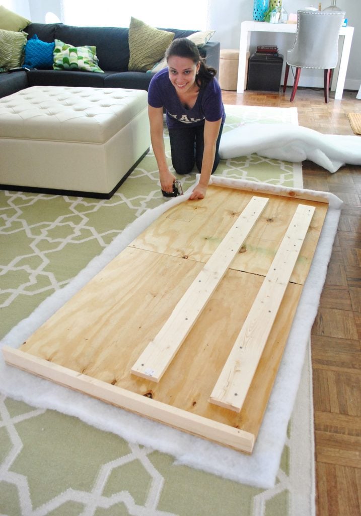 diy-upholstered-headboard-sherry-stapling-batting-717x1024-1 Sherry attaching batting to the back of a headboard frame