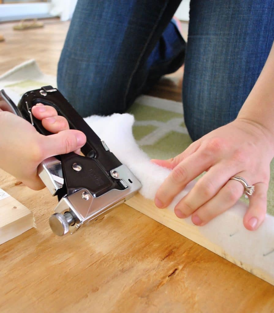 diy-upholstered-headboard-stapling-batting-detail-895x1024-1 Using staple gun to attach batting to back of DIY upholstered fabric headboard