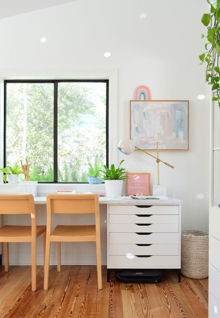 downsized-items-family-room-art-desk-710x1024-1 Kids art desk made from Ikea dressers and laminate marble countertop with wood chairs