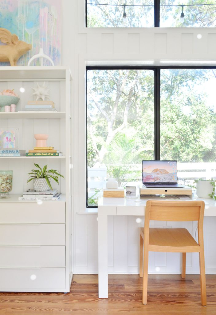 downsized-items-family-room-desk-703x1024-1 West Elm Parsons Desk in large picture window with Ikea Fjalkinge shelves