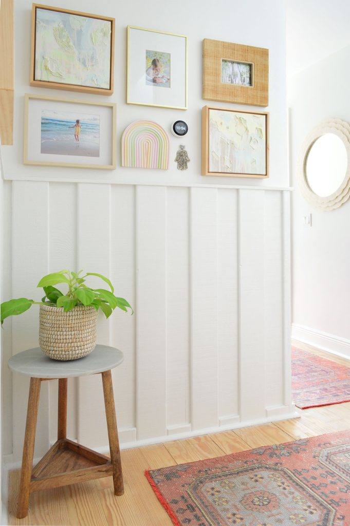 downsized-items-hallway-planter-681x1024-1 White hallway with wainscoting and picture frame collage and turkish runner rugs