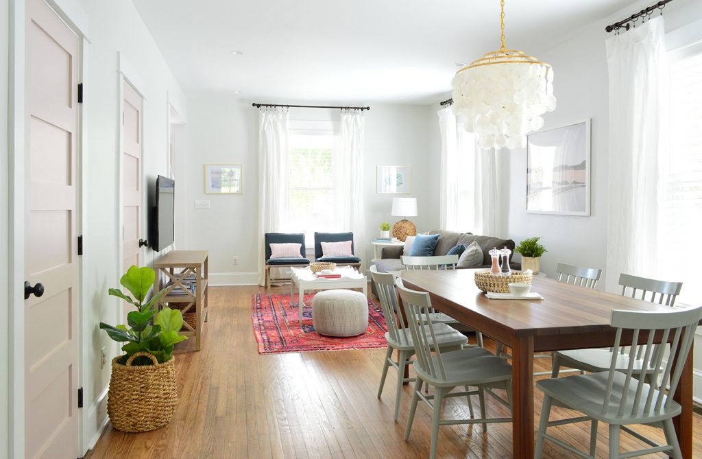 duplex-living-room-pink-full-dining-angle-1024x669-1 Open Living And Dining Room In Bright Beach House With Pink Doors