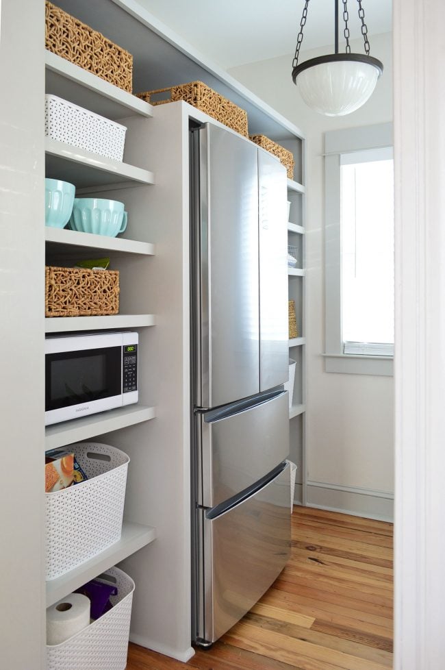 ep83-beach-house-pantry-painted-650x978-1 after photo of built in pantry shelving project painted gray with baskets on shelves