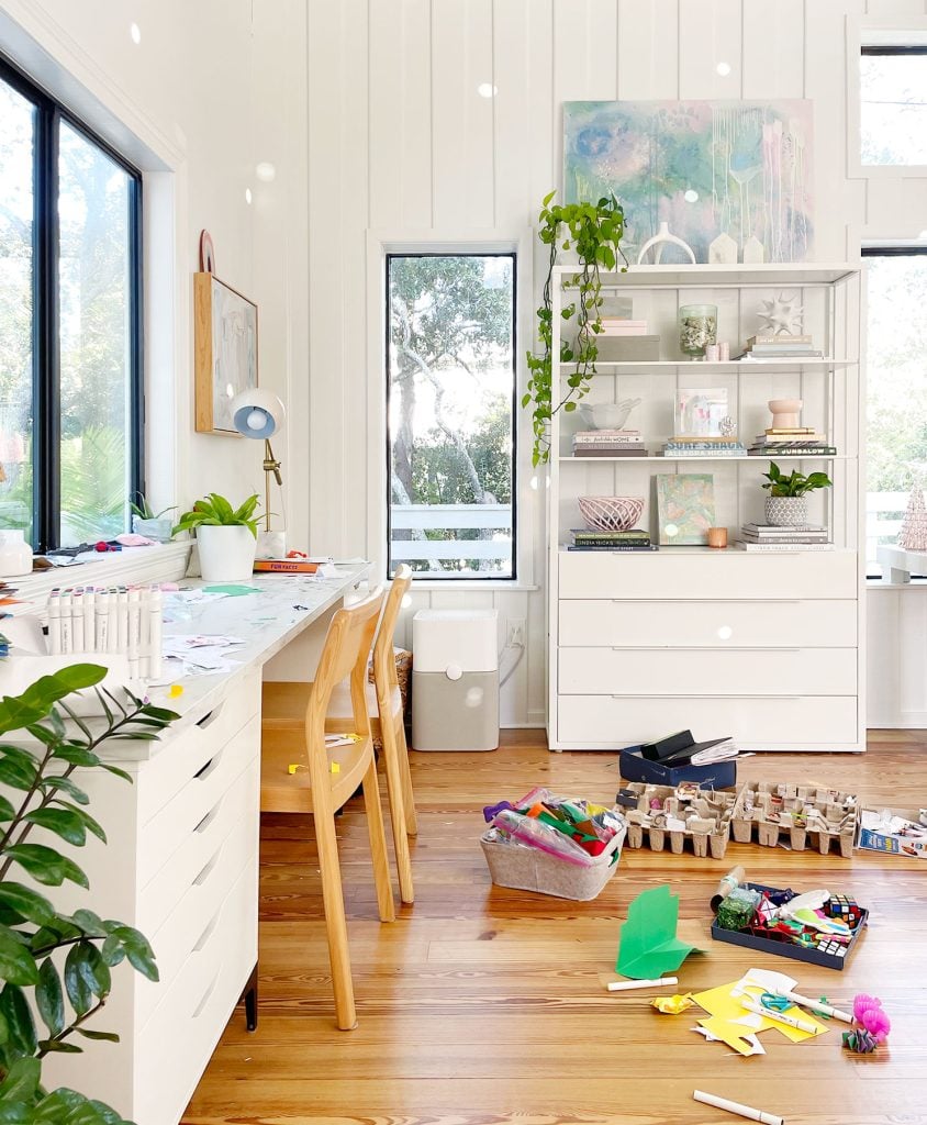 family-room-art-desk-with-kid-craft-on-floor-844x1024-1 Bright Family Room Craft Space With Desk And Floor Covered With Craft And Art Supplies