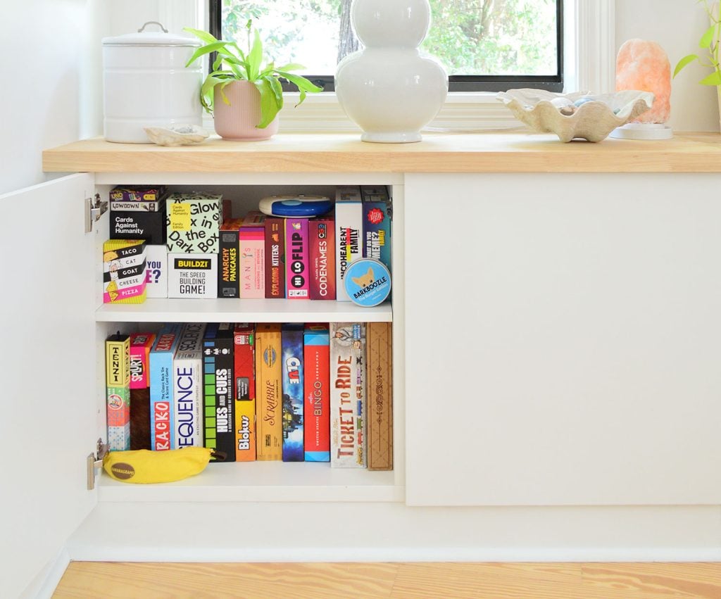 favorite-family-board-games-in-besta-cabinet-hero-1024x851-1 Ikea Besta Cabinet With Door Open Showing Family Board Game Storage