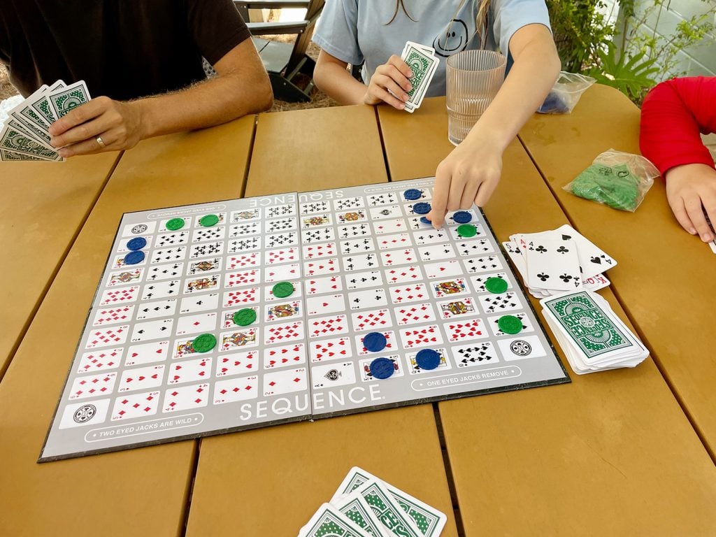 favorite-family-games-sequence-board-1024x768-1 Family Playing Sequence Board Game On Outdoor Table