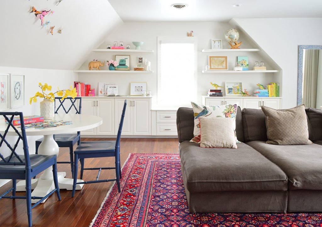 final-bonusroom-2020-straight-on-1024x723-2 Family bonus play room with traditional rug and oversized couch and built in shelves
