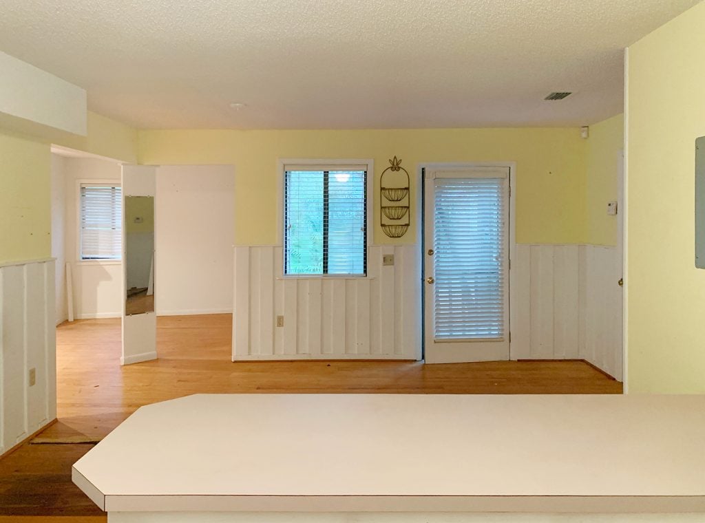 florida-before-front-door-from-kitchen-1024x760-1 Before photo of kitchen with yellow walls into bedroom