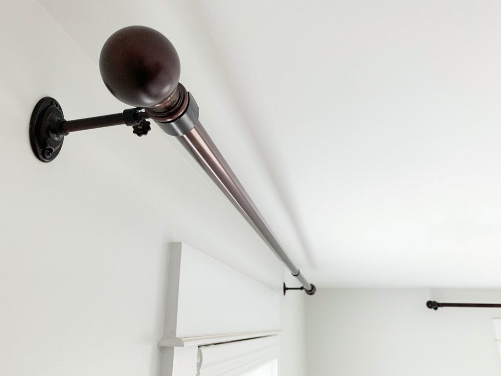 hanging-curtain-rods-final-hung-up-1024x768-1 Allen + Roth Bronze curtain rods hung against white wall