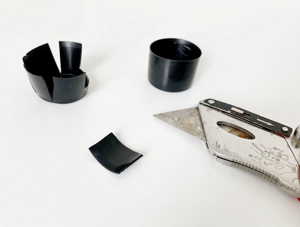 hanging-curtain-rods-plastic-caps-cut-1024x775-1 Cut pieces of black plastic to help make curtain rod more level